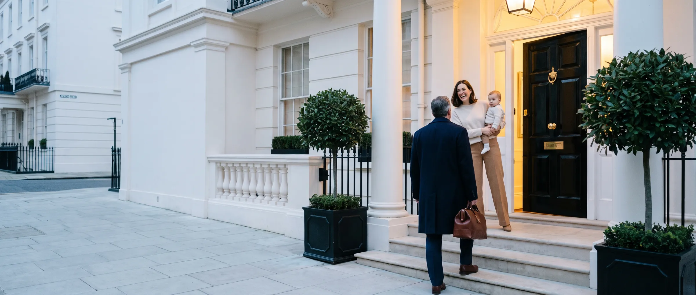 A physician with his bag climbing the steps of a white Belgravia townhouse at dusk, welcomed in by a young mother holding her baby