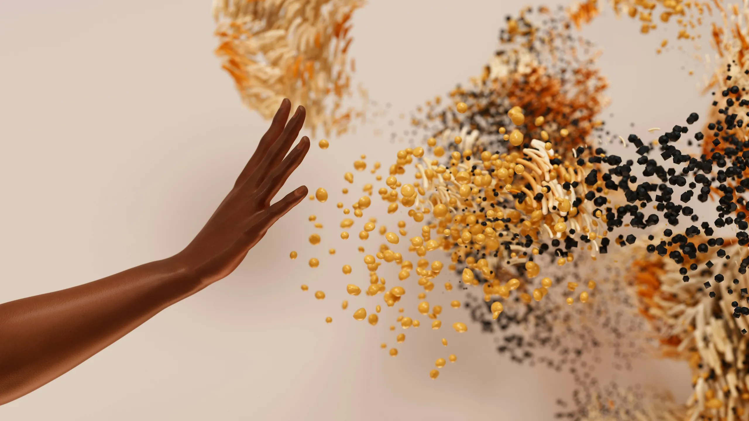A hand reaching into a drift of amber and black particles