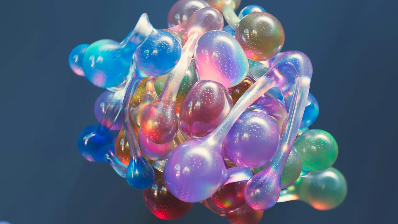 A cluster of glossy translucent spheres in blue, violet and pink