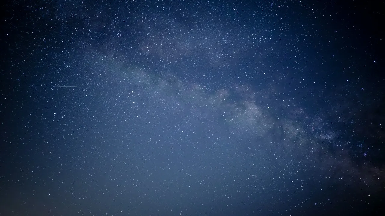 The Milky Way crossing a deep blue night sky full of stars