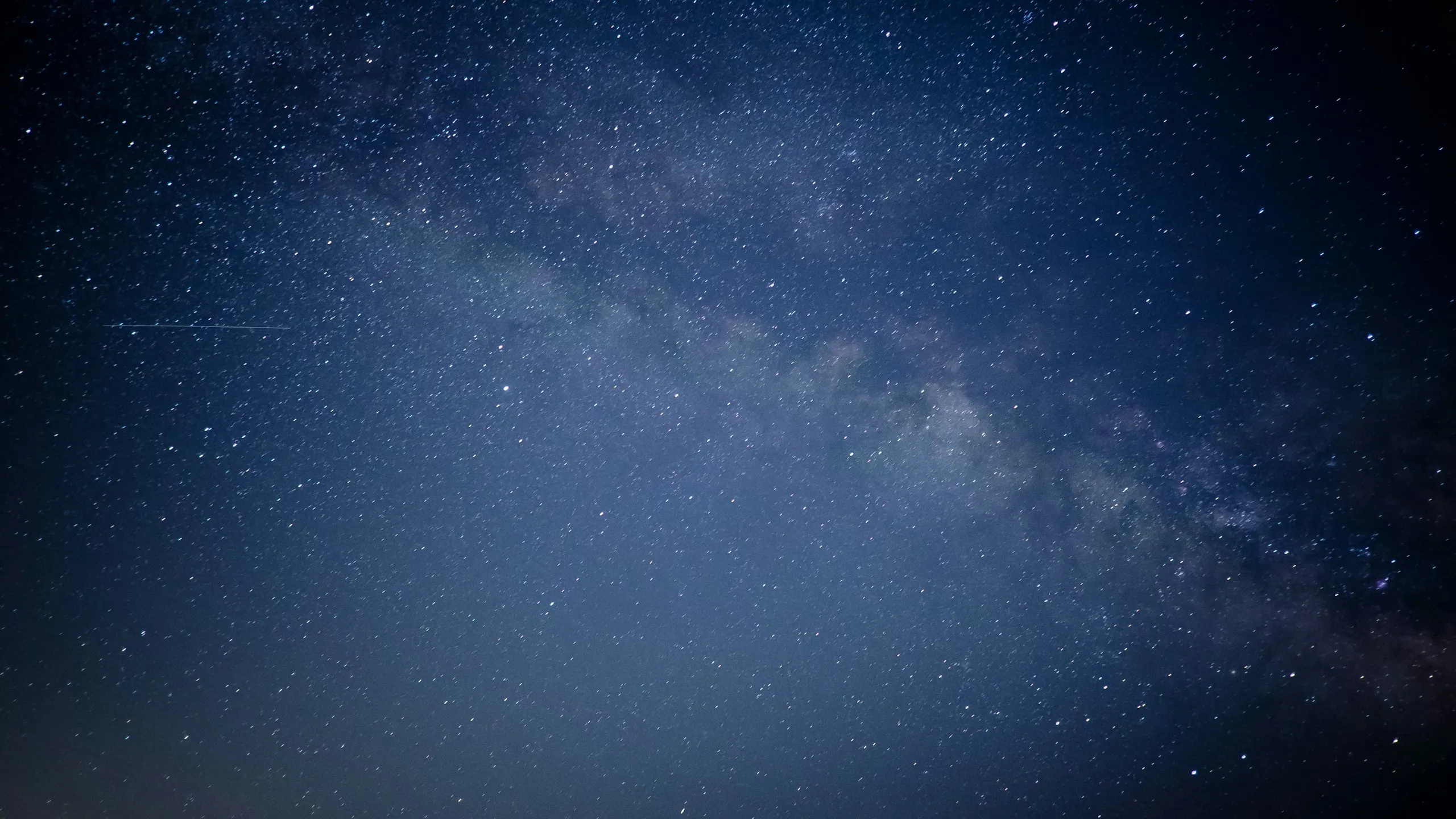 The Milky Way crossing a deep blue night sky full of stars