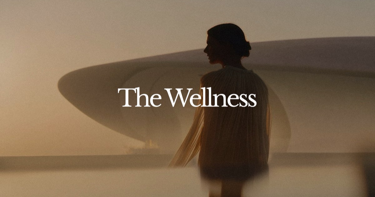 A woman in silhouette against soft architectural light, with the wordmark centred