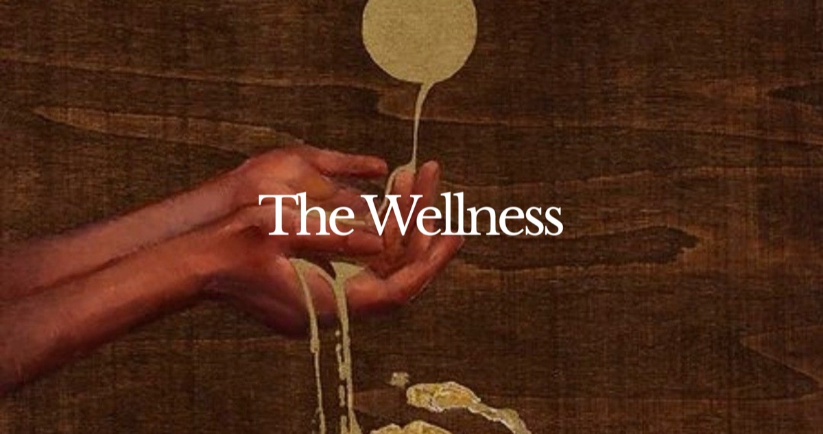Hands catching gold paint against dark wood