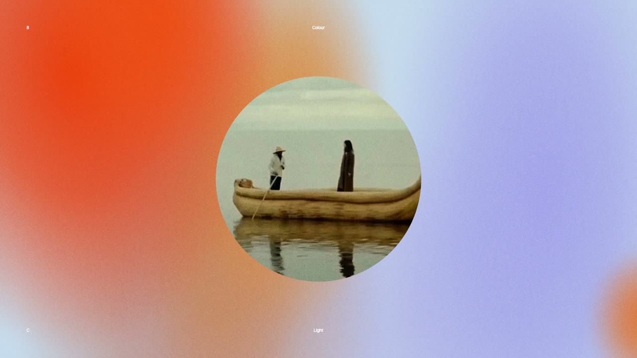 A round window of film footage opening on a poster field